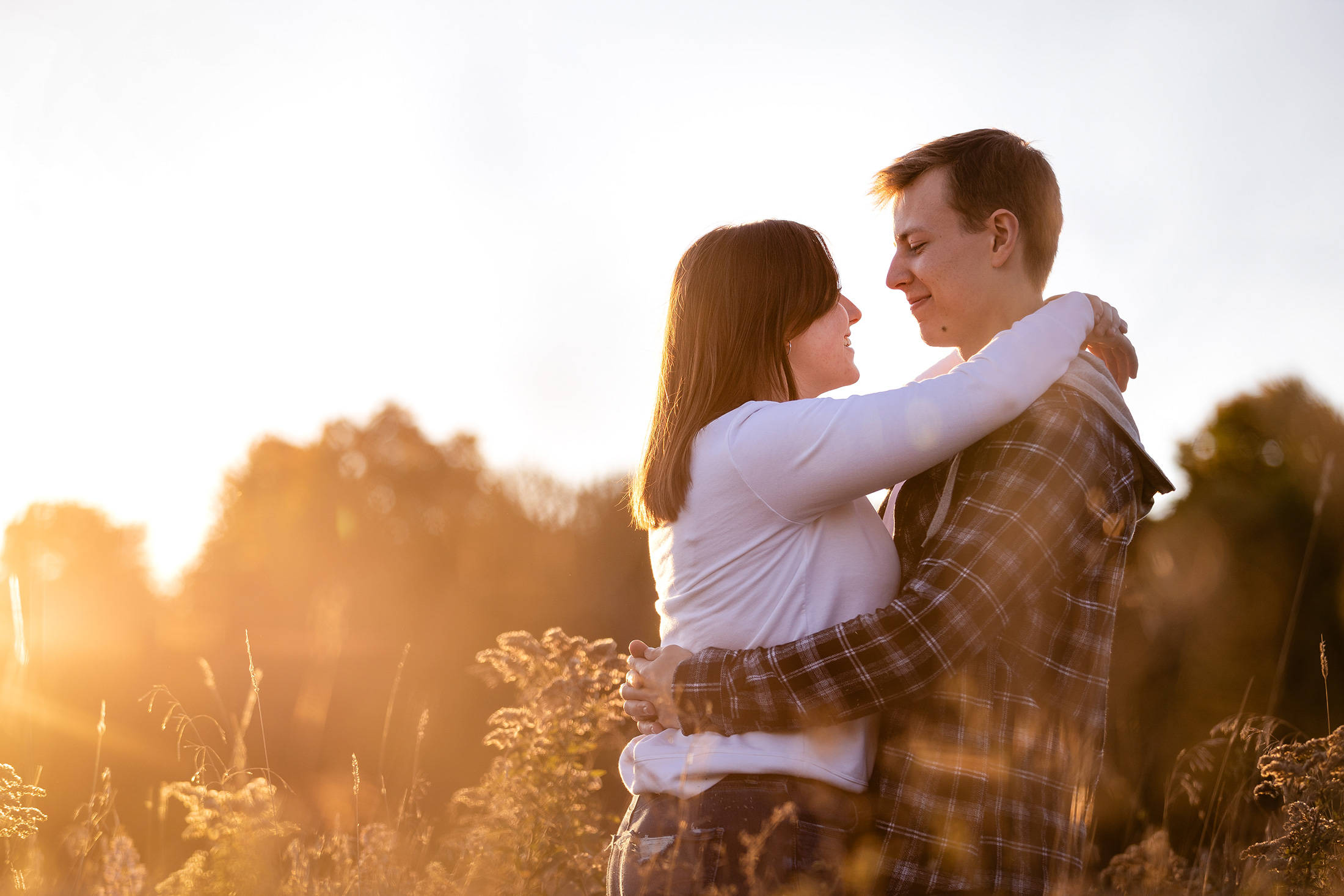 Couple photographed during a warm sunset session