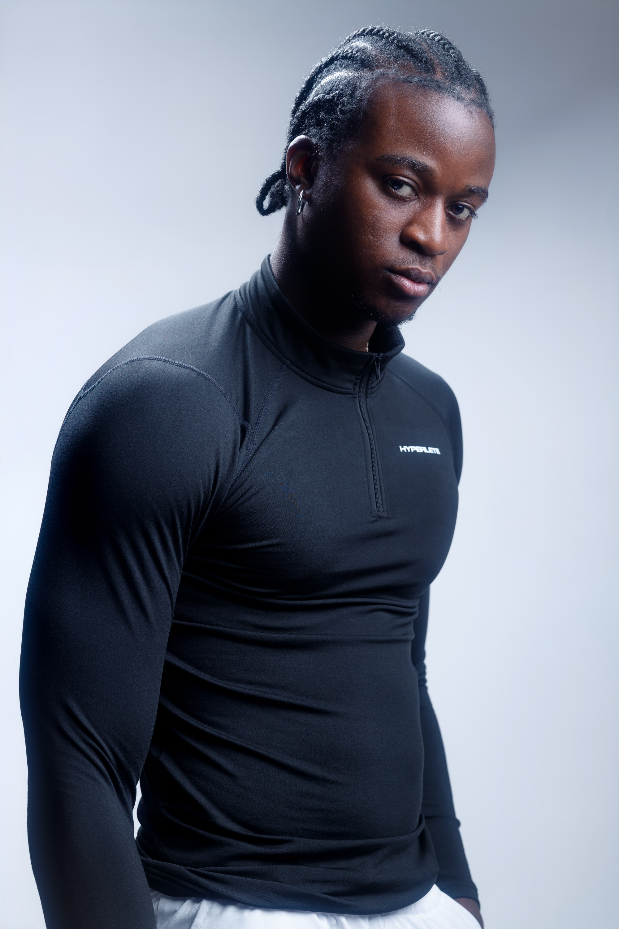 Studio portrait of a male athlete in black performance wear