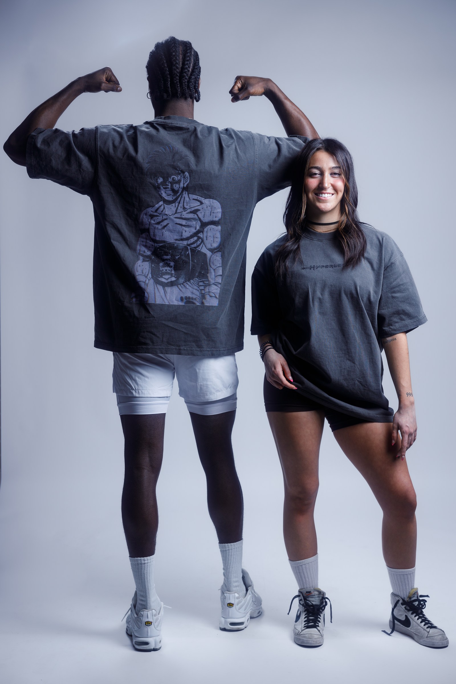 Two athletic apparel models presenting graphic training shirts