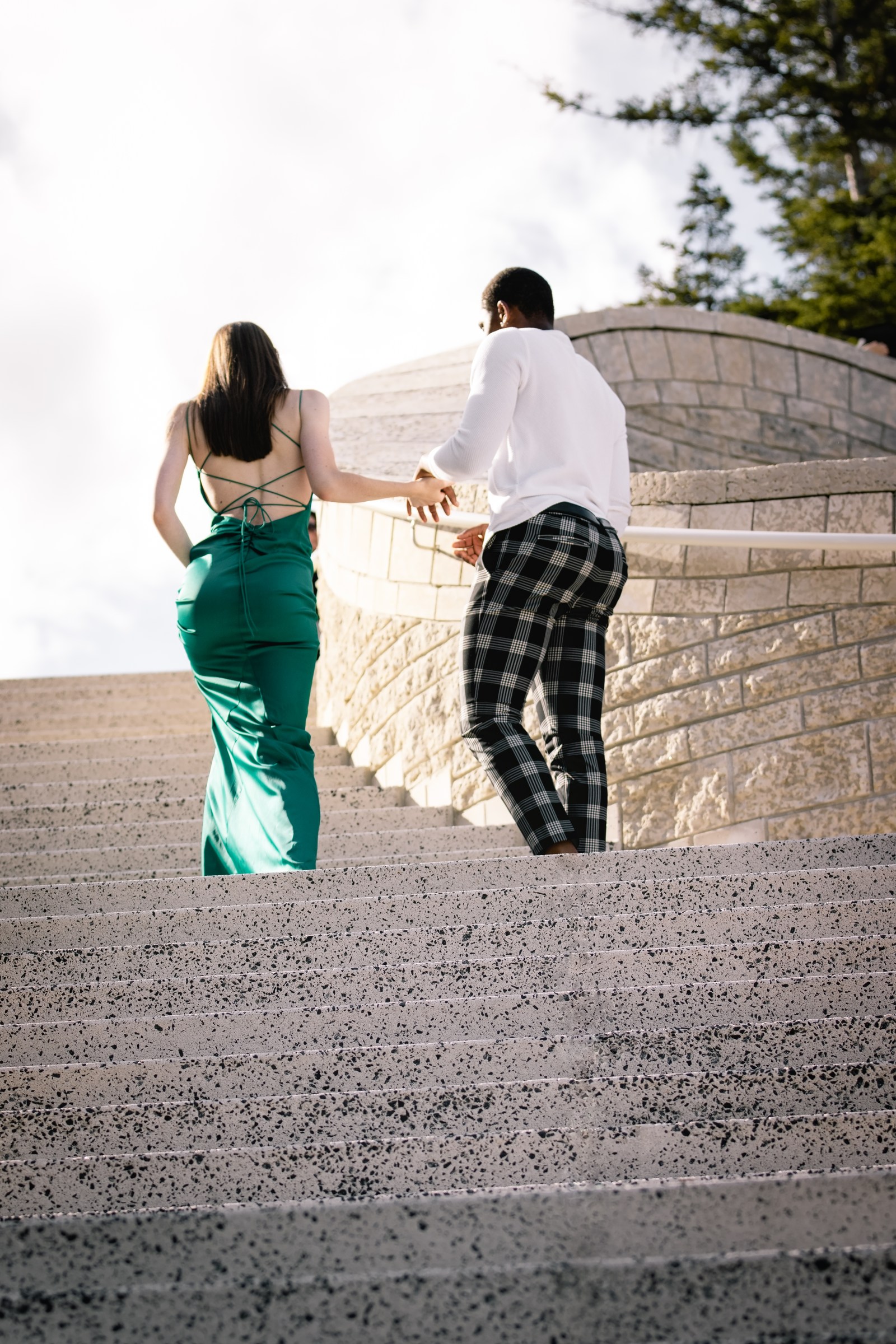 Couple walking together beside monumental stone architecture