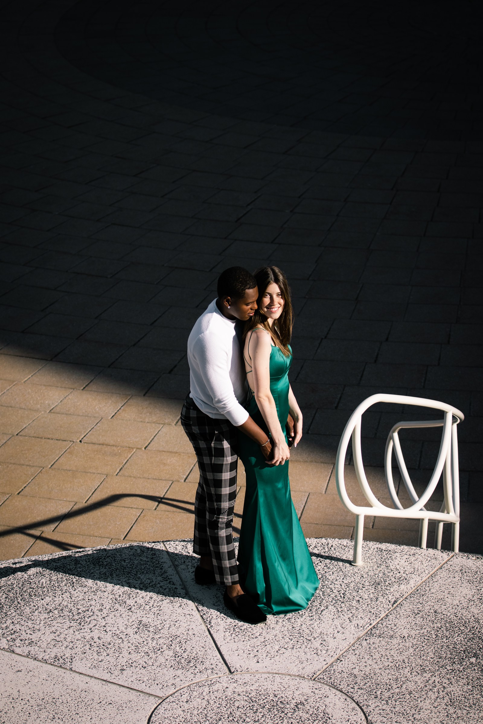 Couple embracing in graphic architectural light