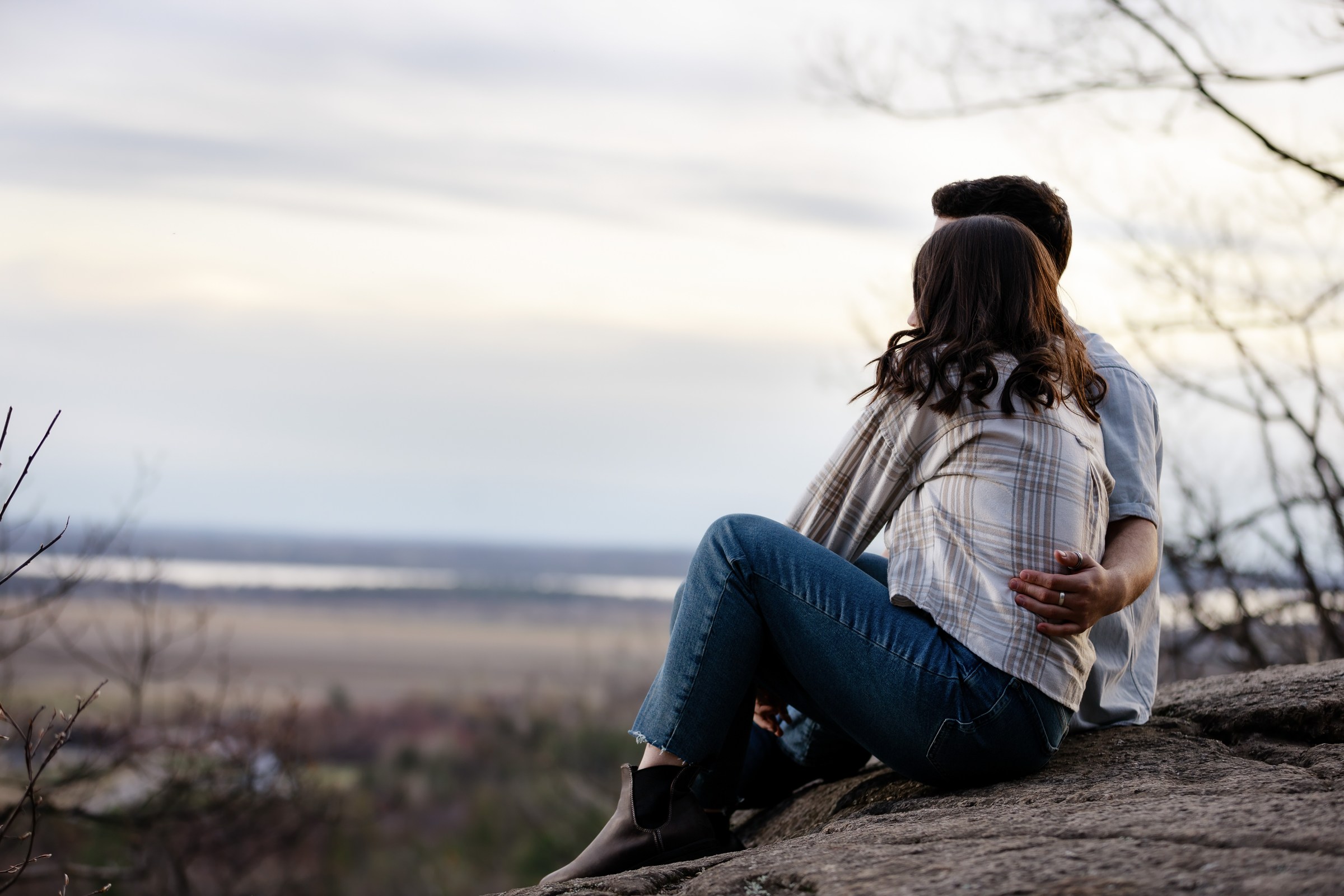 Couple seated together at a scenic overlook