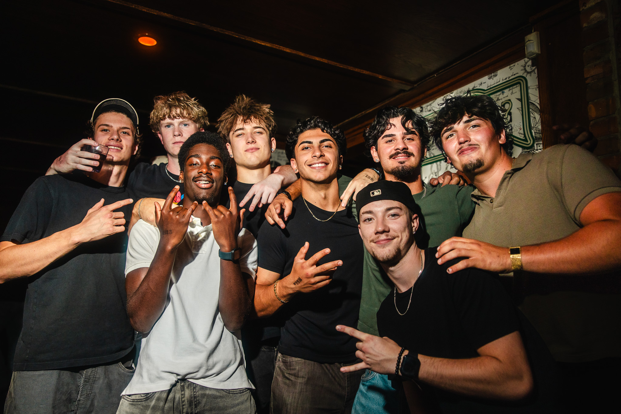 Large group of friends celebrating together at a lively club event