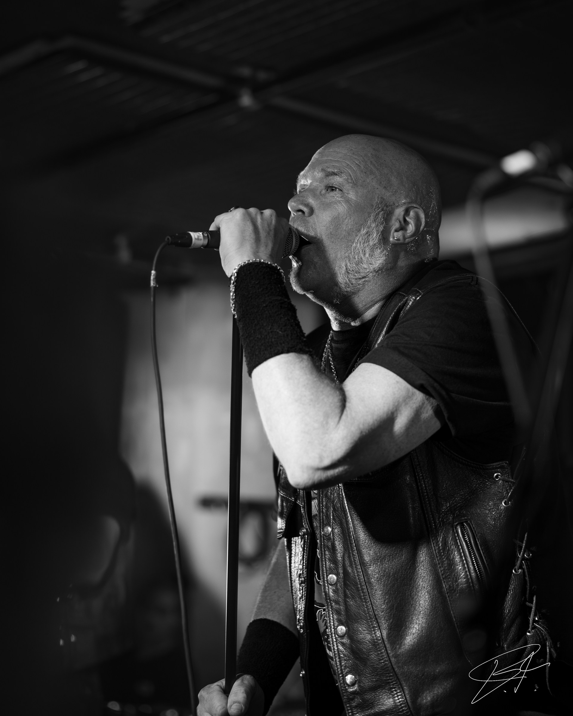 Atmospheric live music portrait through stage haze
