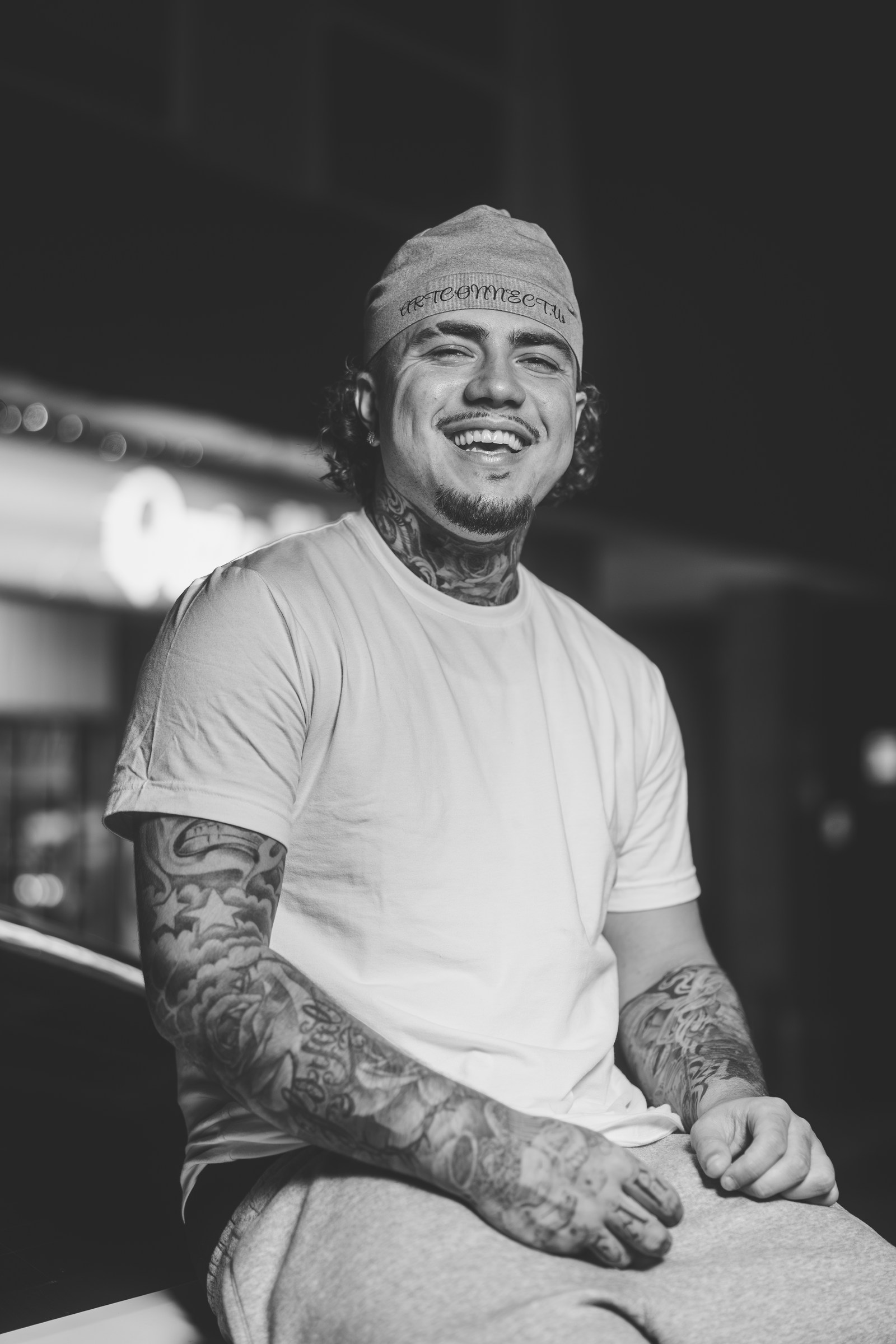 Black-and-white character portrait with a relaxed smile