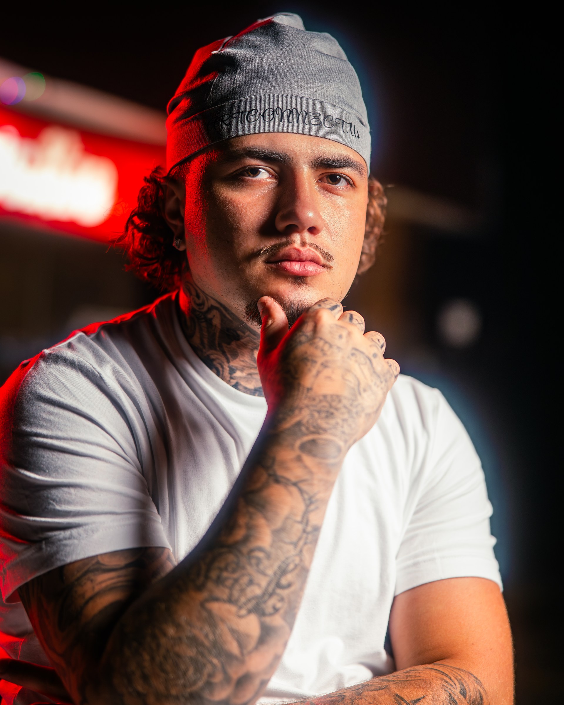 Moody editorial portrait under dramatic red light