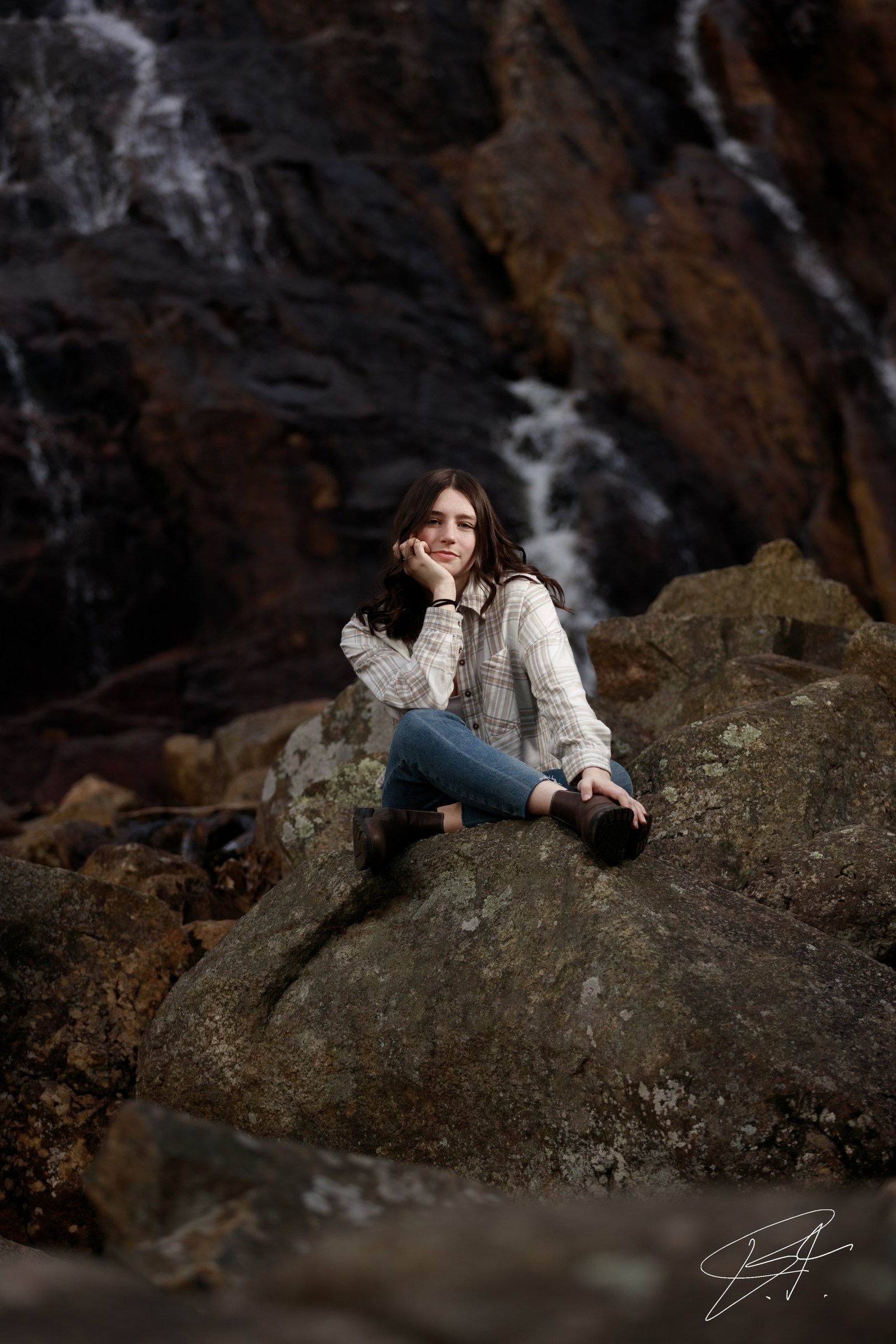 Outdoor portrait framed by soft greenery