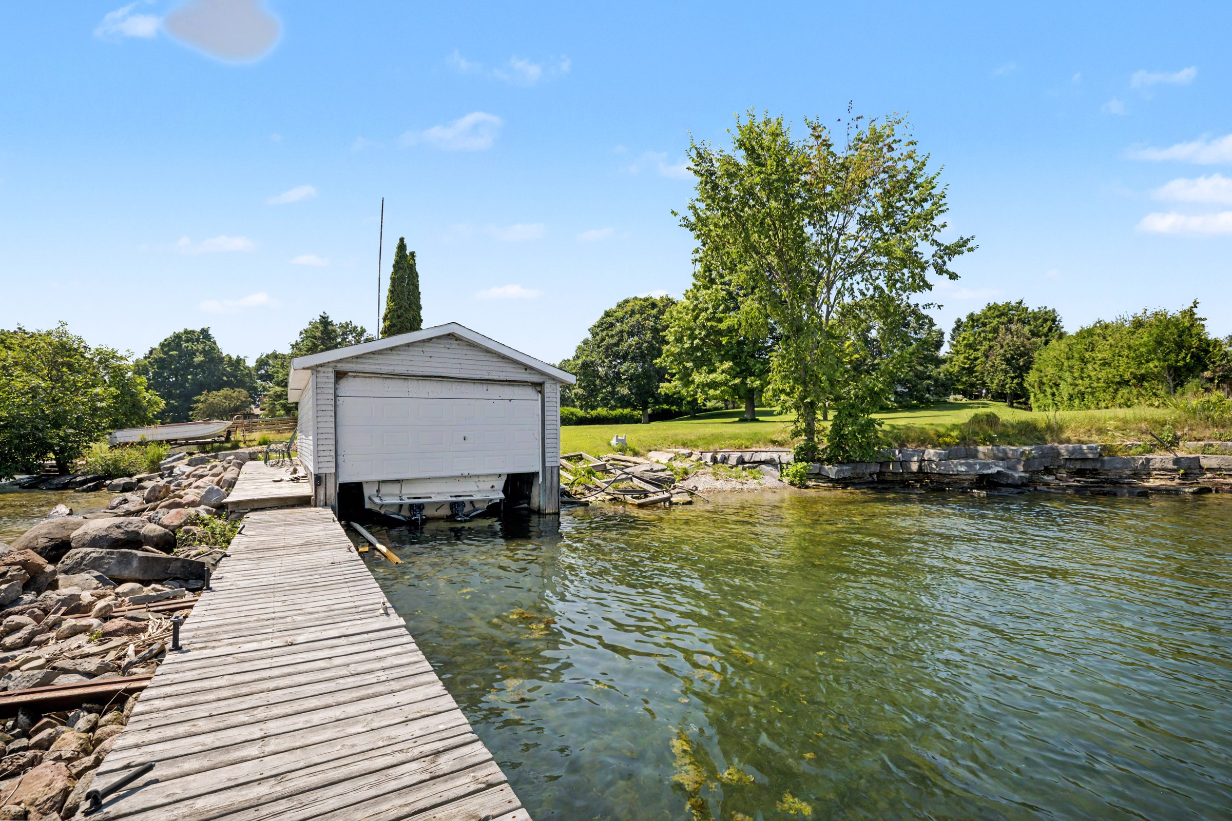 Private dock extending toward a waterfront boathouse
