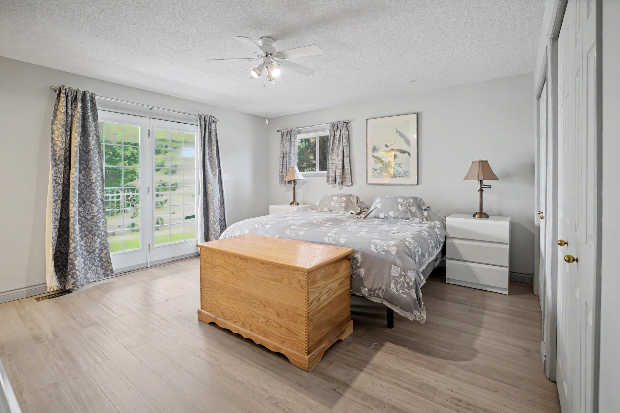 Primary bedroom opening toward an outdoor porch