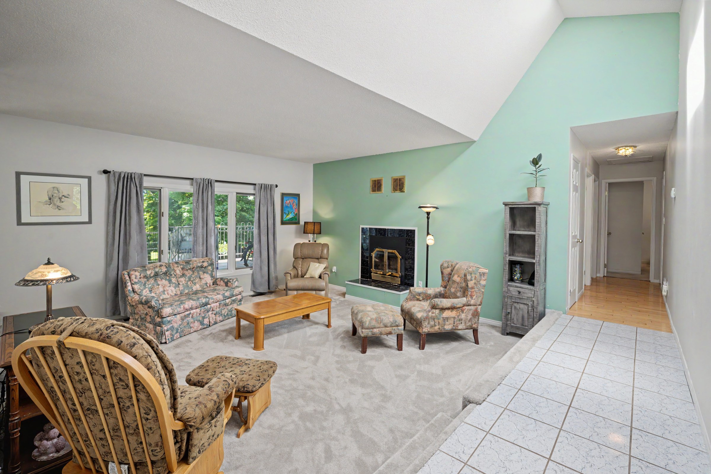 Vaulted living room centered around a fireplace