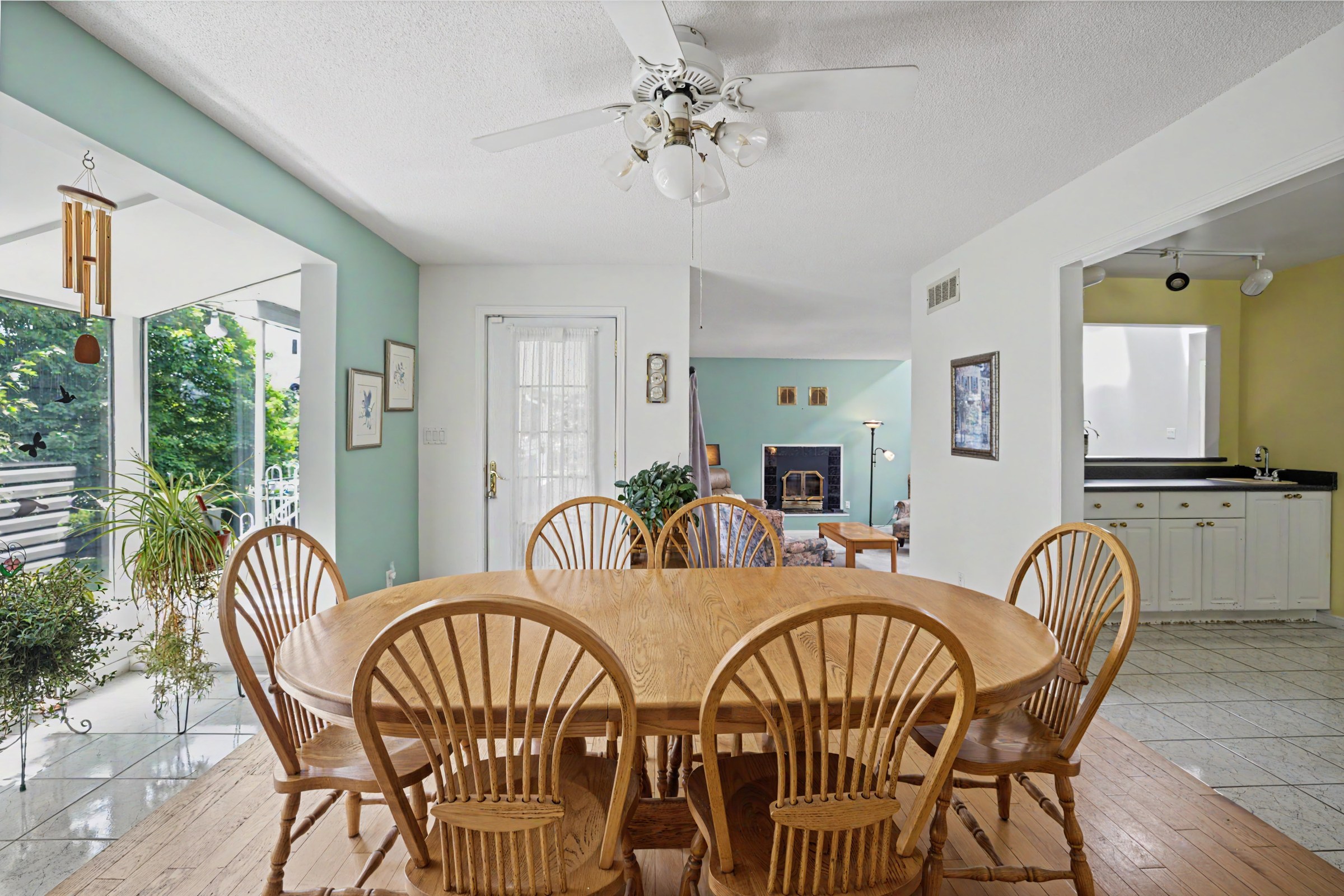 Dining room flowing into a bright sunroom