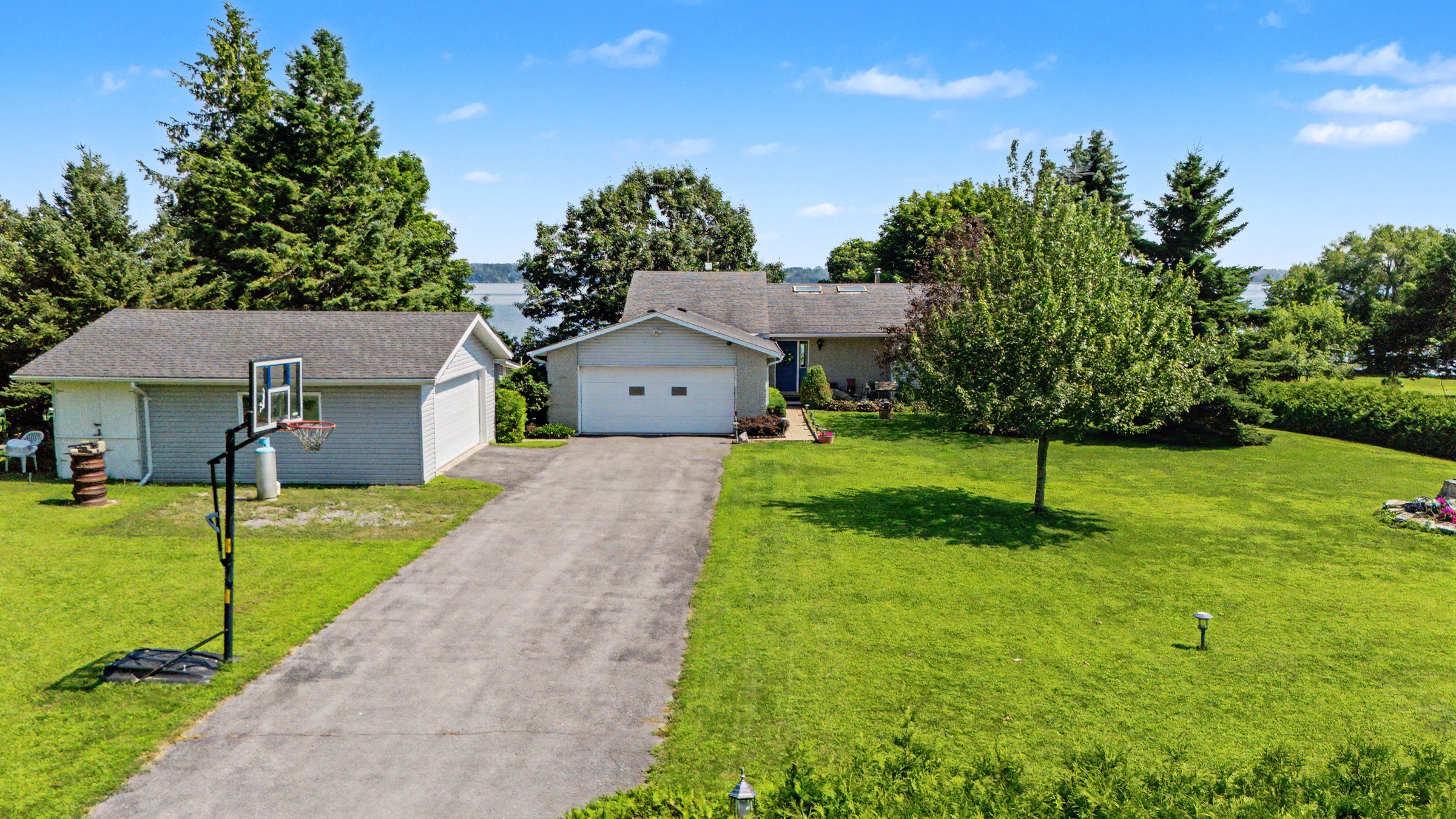 Aerial view showing the home and waterfront setting