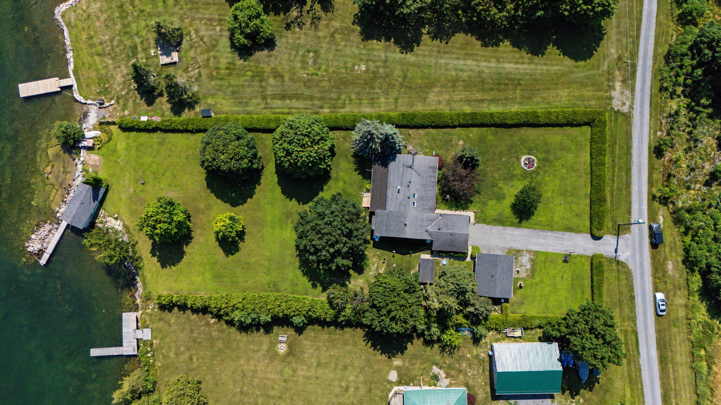 Drone view of the property surrounded by mature trees