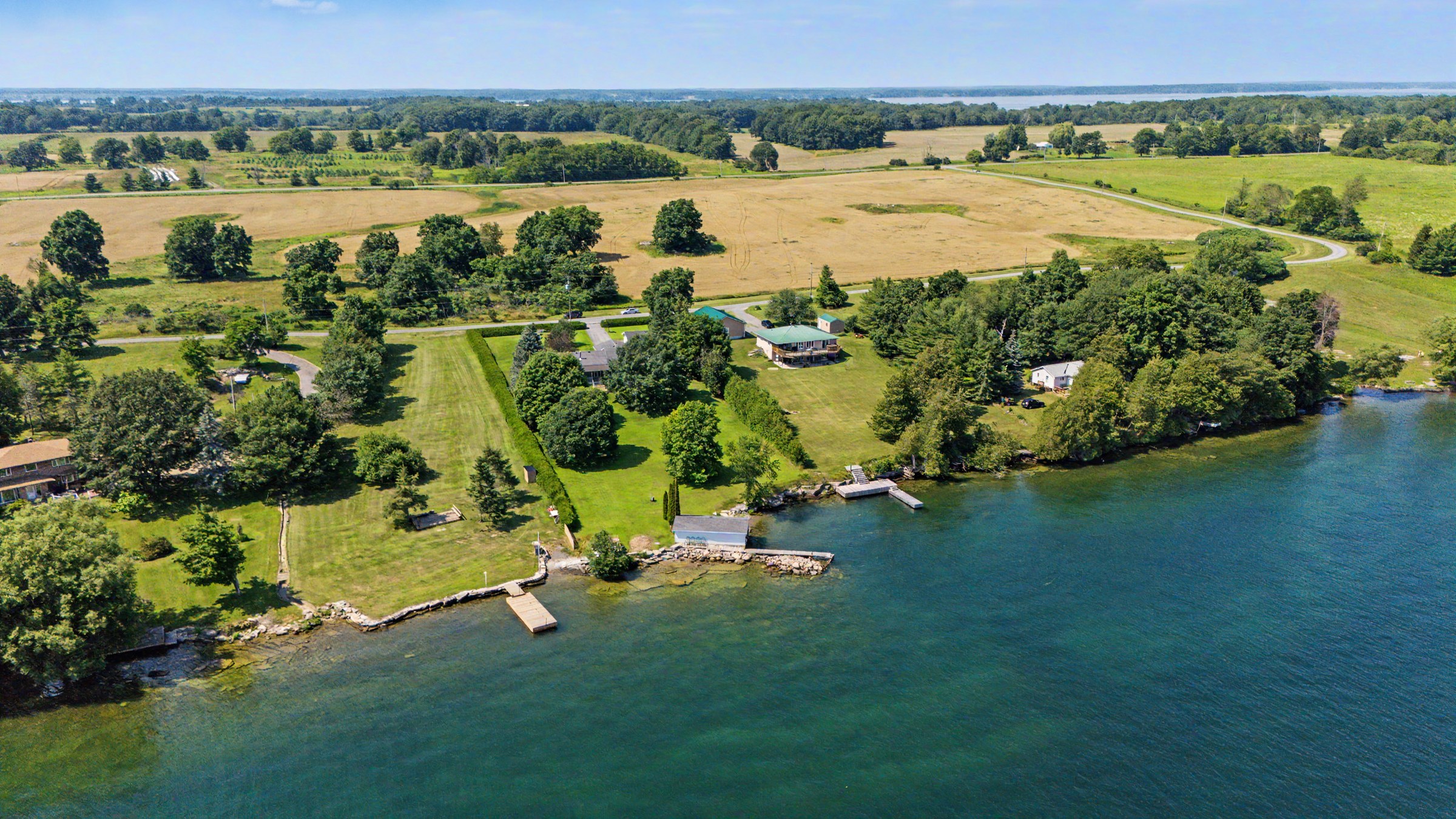 Elevated aerial perspective of the shoreline and residence
