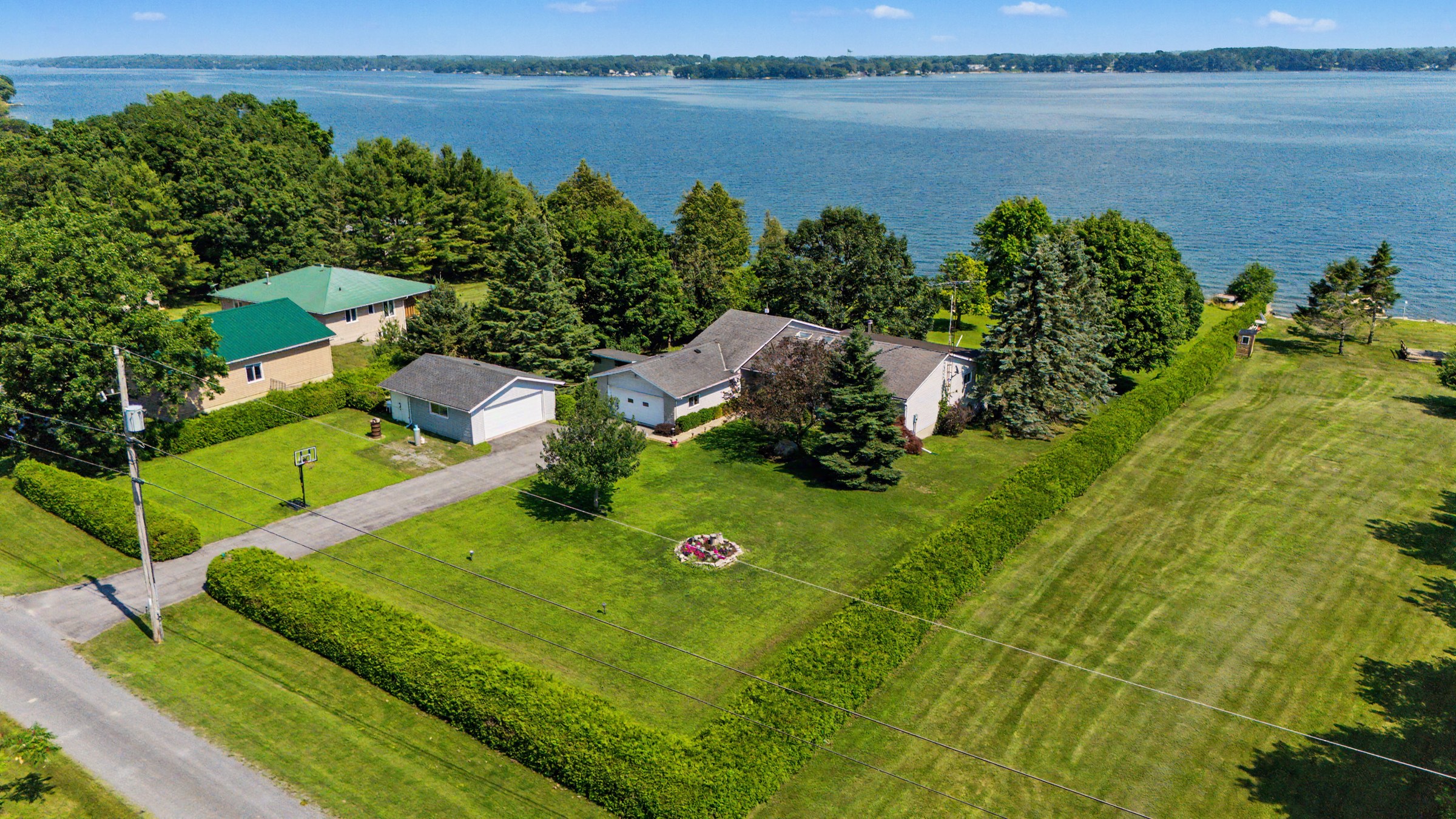 Wide drone view of the full waterfront property