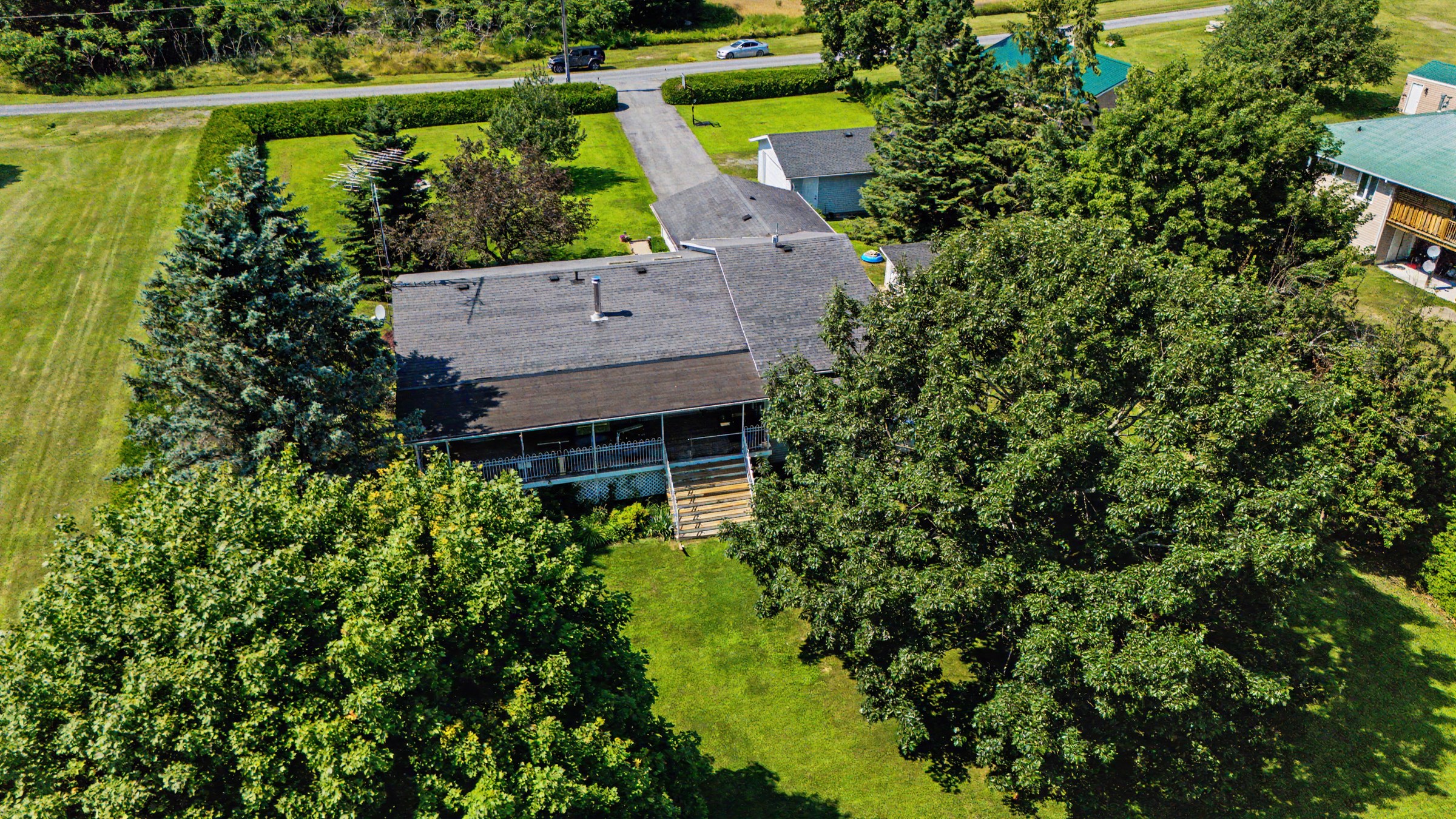 Aerial composition highlighting the home, grounds, and water