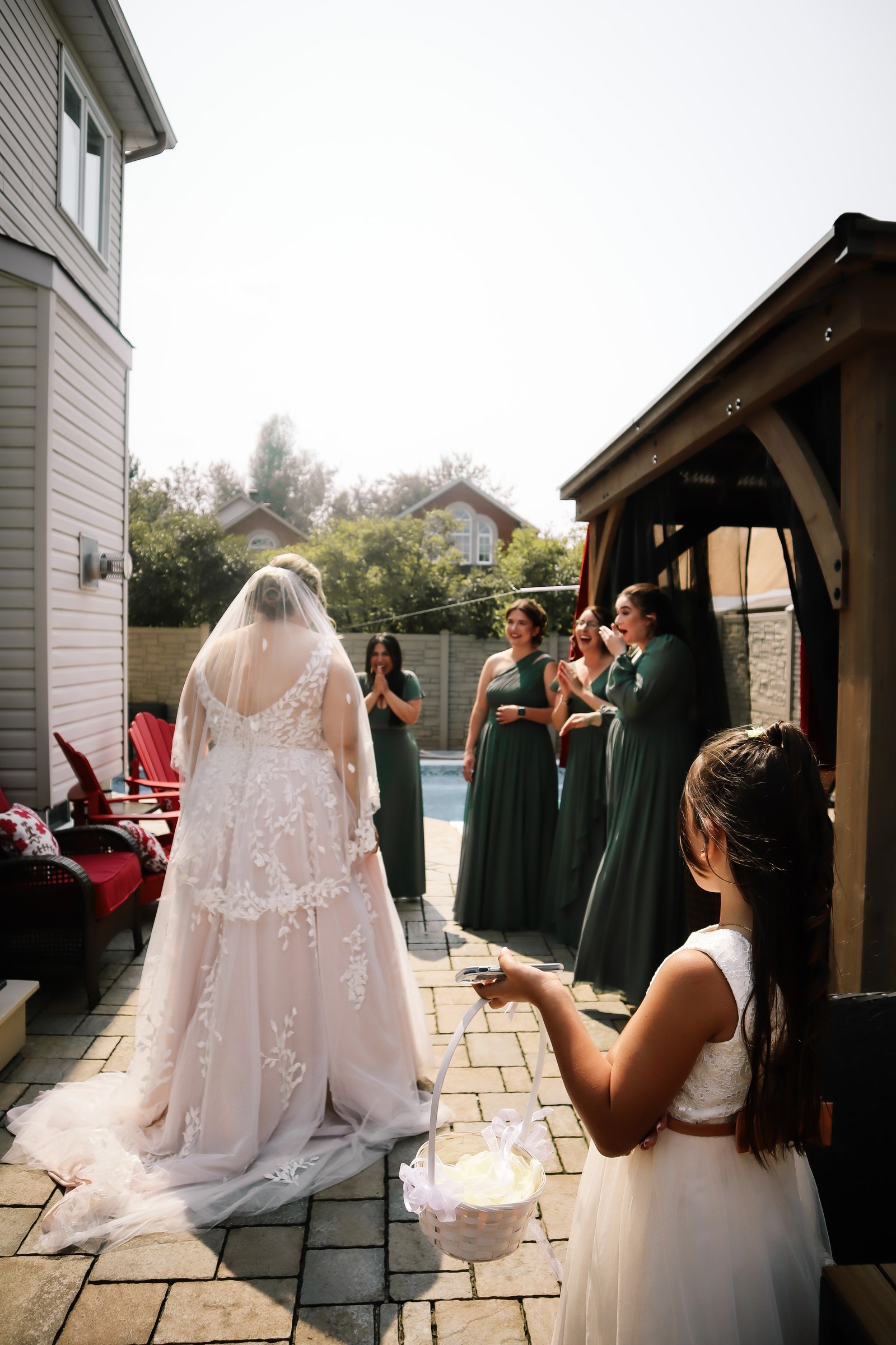 Bride revealing her wedding dress to her bridesmaids